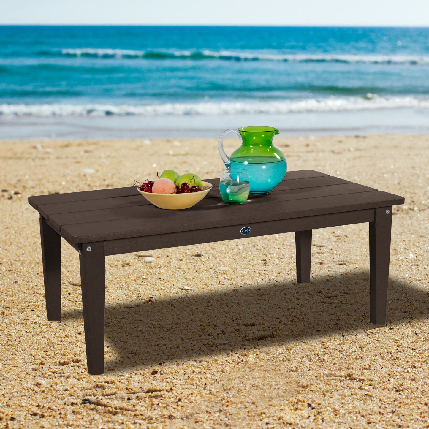 Brown Sunrise Coast conversation table on beach with water pitcher and fruit
