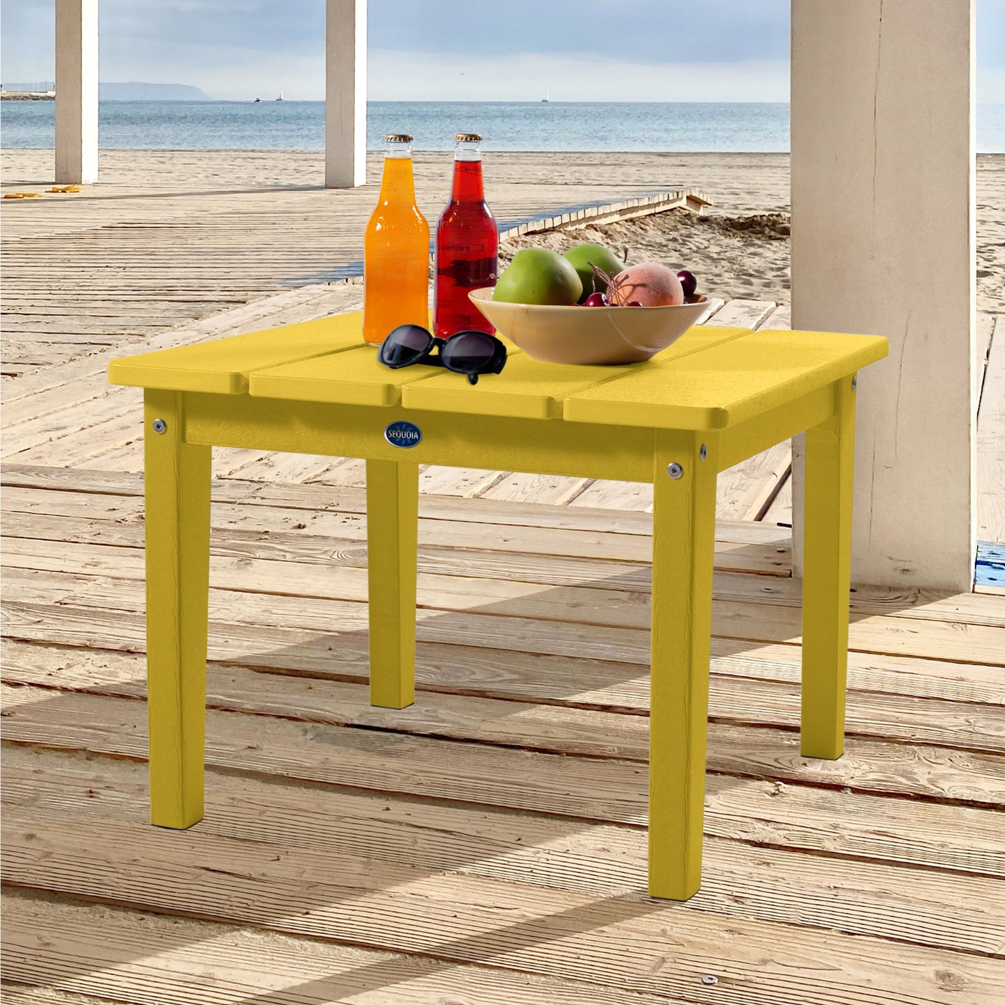 Green Sunrise Coast large side table with drinks, fruit, and sunglasses