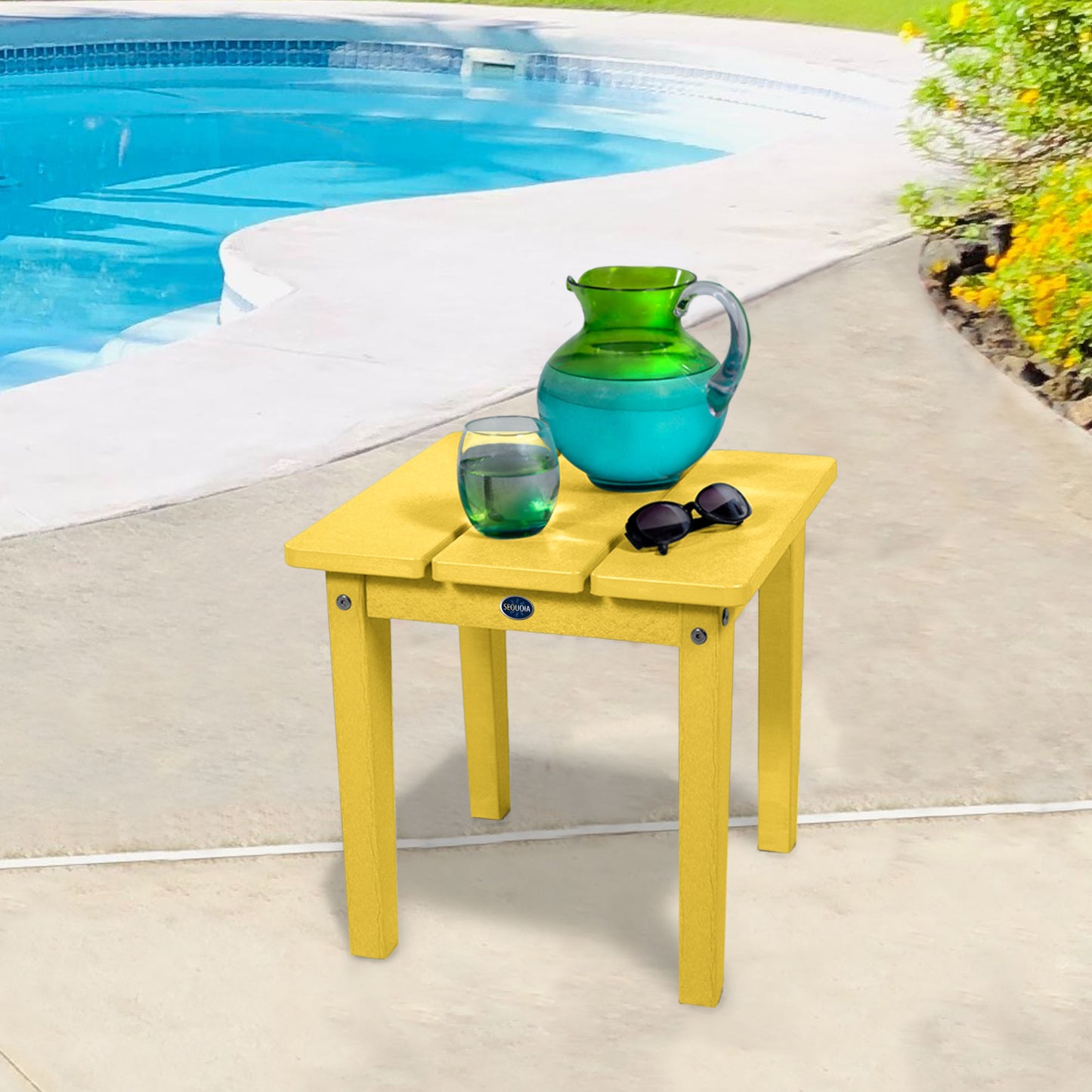 Yellow Sunrise Coast small side table with water and sunglasses by a pool