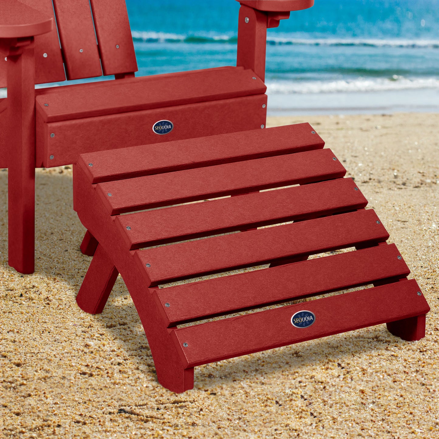 Red Sunrise Coast folding ottoman and Adirondack chair on beach