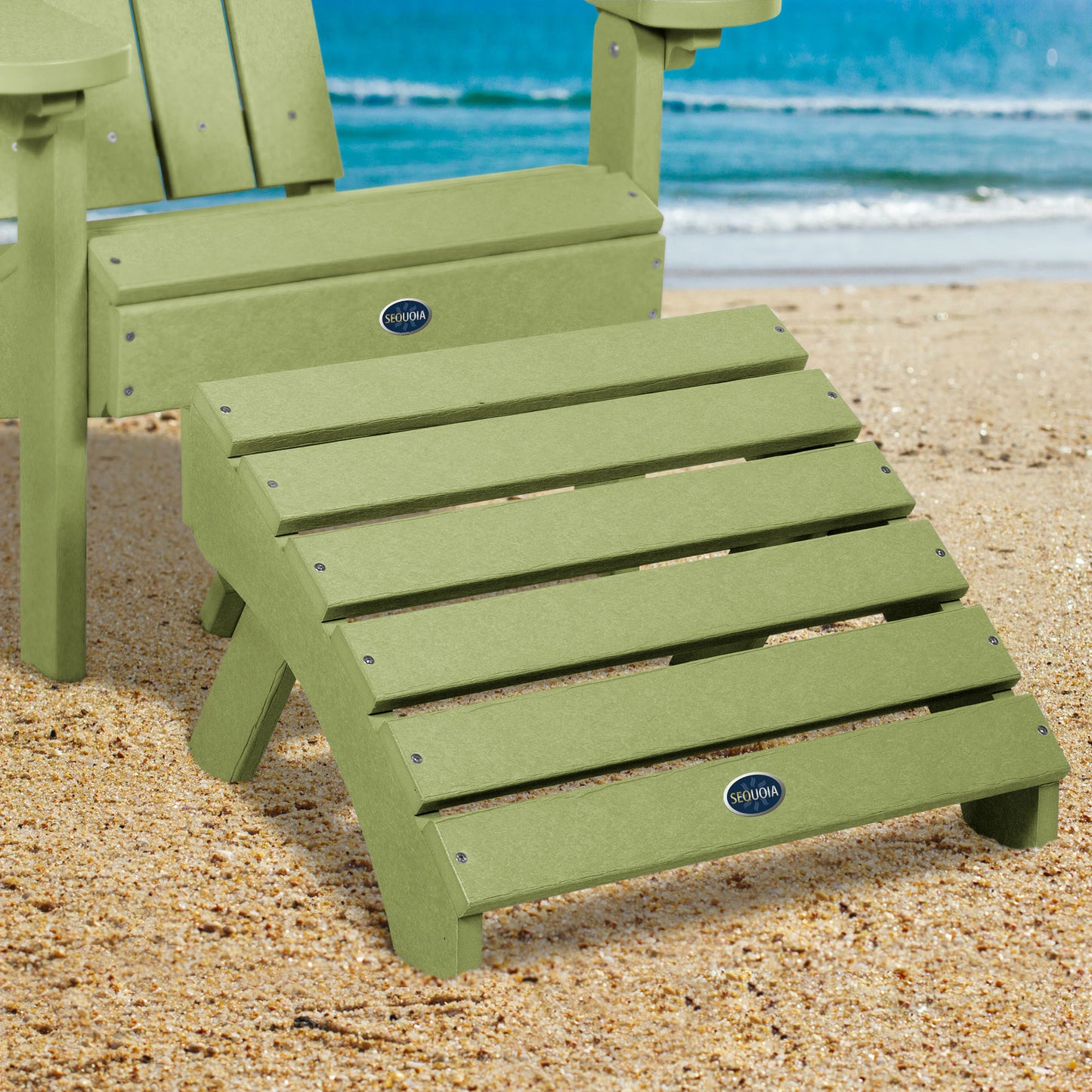 Green Sunrise Coast folding ottoman and Adirondack chair on beach