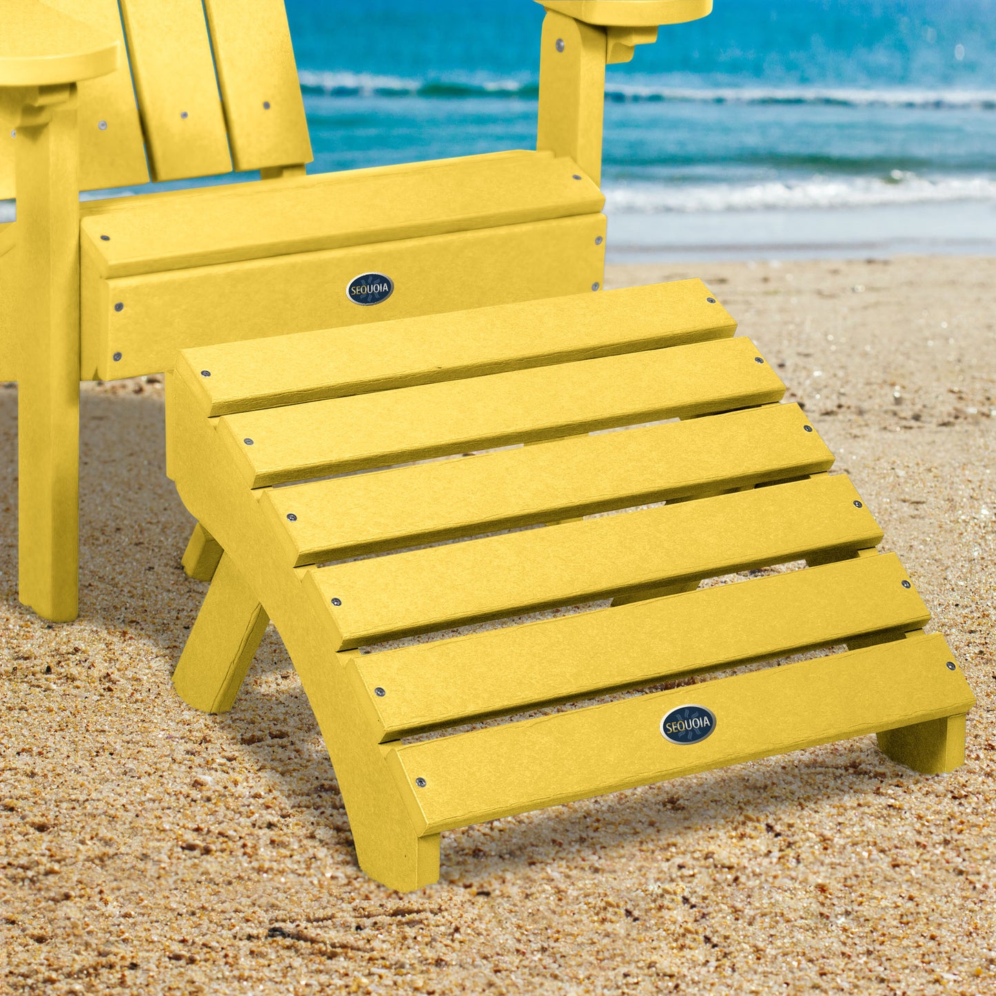 Yellow Sunrise Coast folding ottoman and Adirondack chair on beach