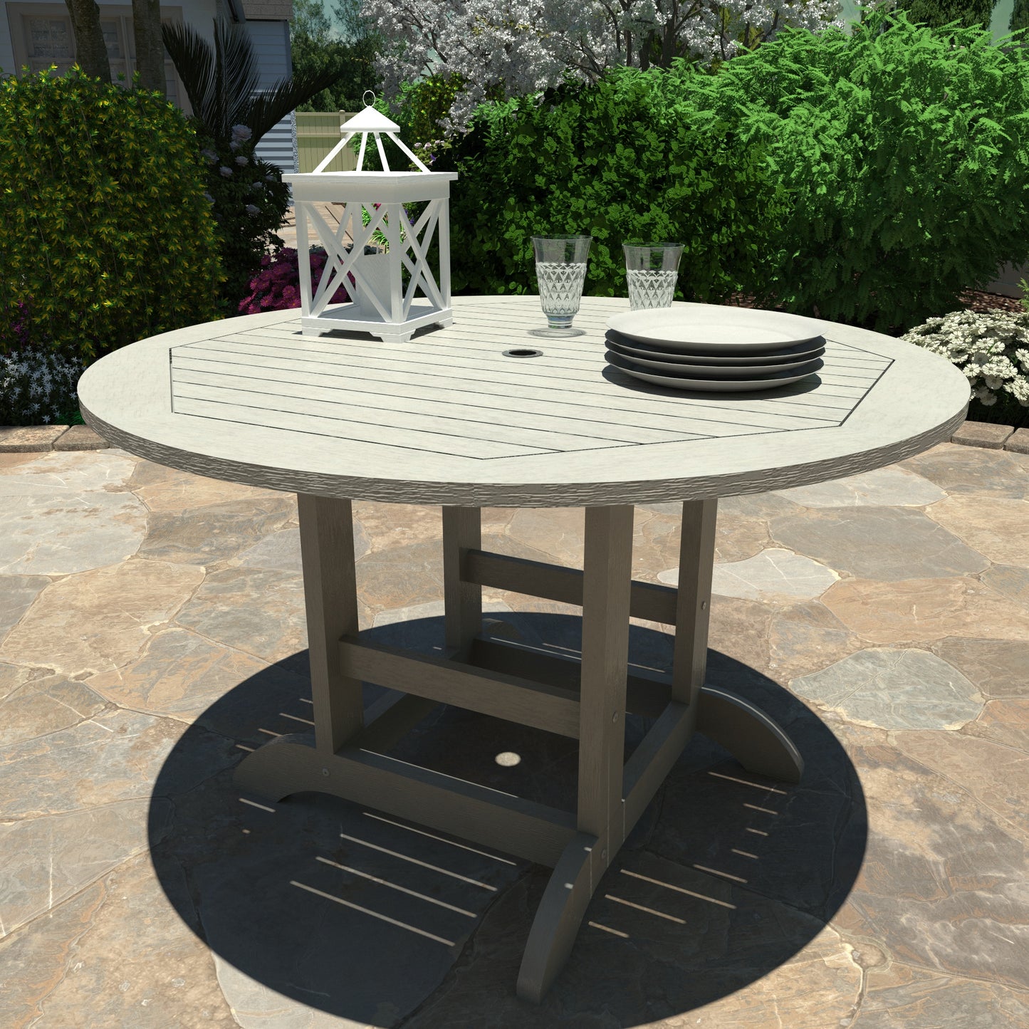 Light gray 48in diameter dining height table with lantern, plates, and glasses