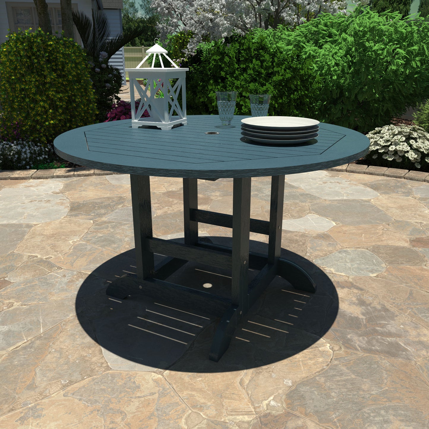 Light blue 48in diameter dining height table with lantern, plates, and glasses