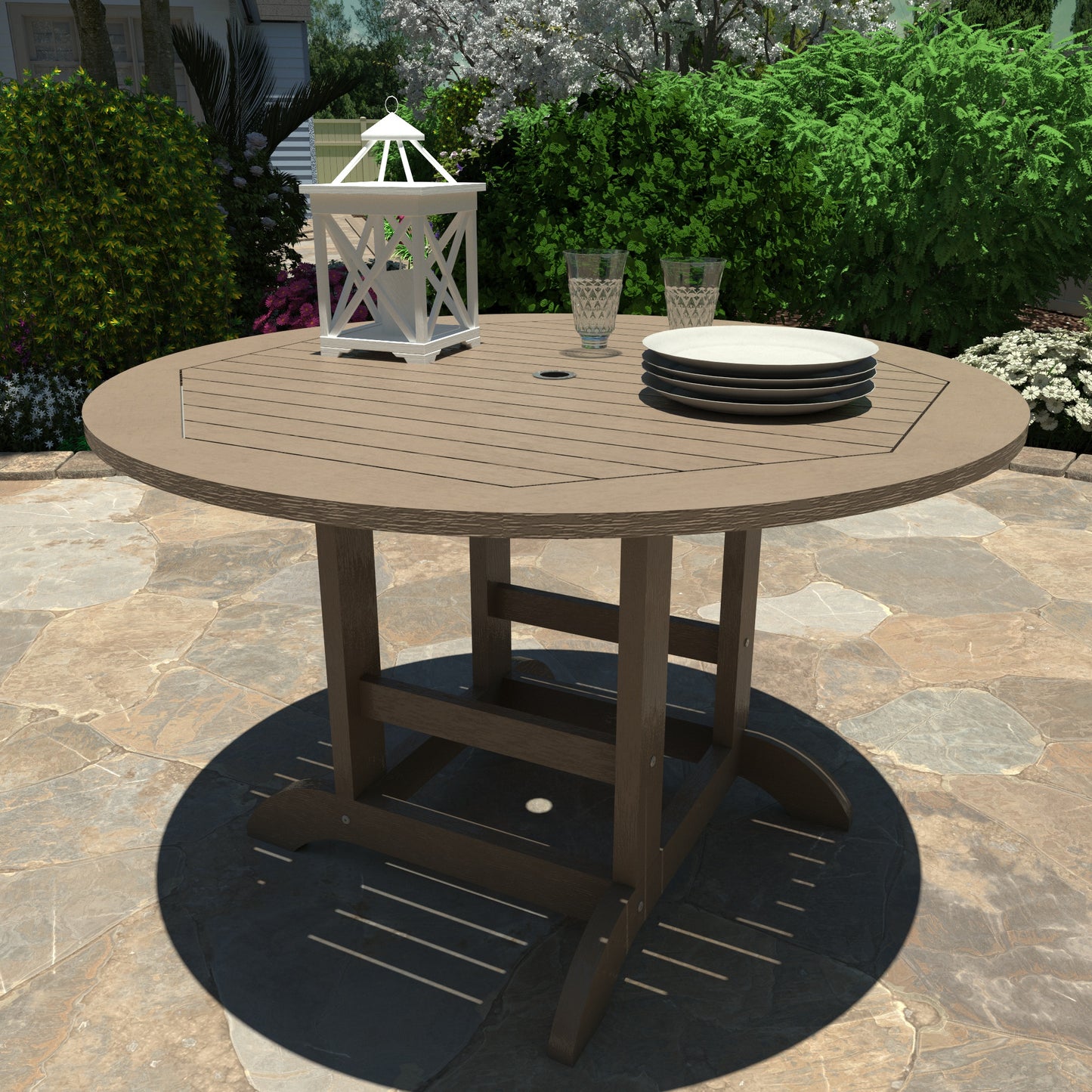 Light brown 48in diameter dining height table with lantern, plates, and glasses