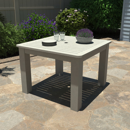 Light gray Homestead Square 42x42 table with plates and plant