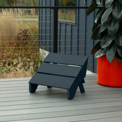 Dark blue Granite Hills folding ottoman on a deck