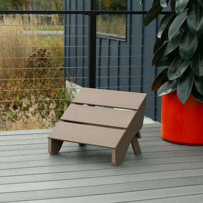 Light brown Granite Hills folding ottoman on a deck