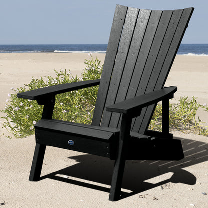 Black Granite Hills folding and reclining Adirondack chair on a beach