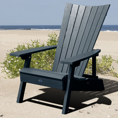 Dark blue Granite Hills folding and reclining Adirondack chair on a beach