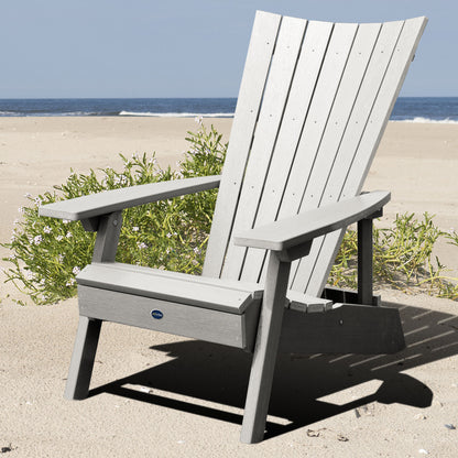 Light gray Granite Hills folding and reclining Adirondack chair on a beach