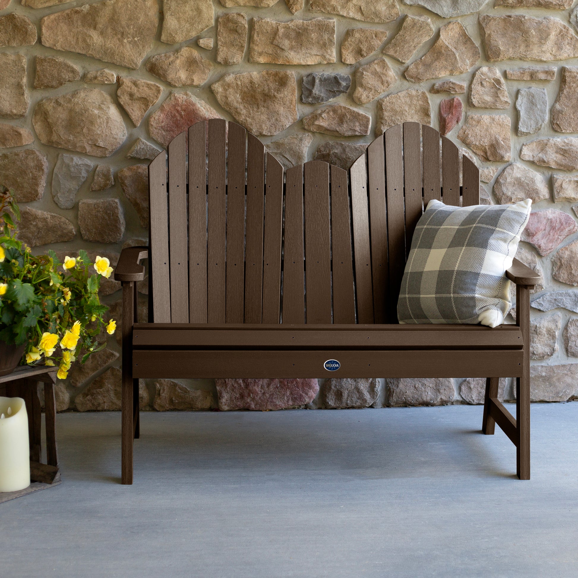 Brown Lighthouse Adirondack bench against stone wall