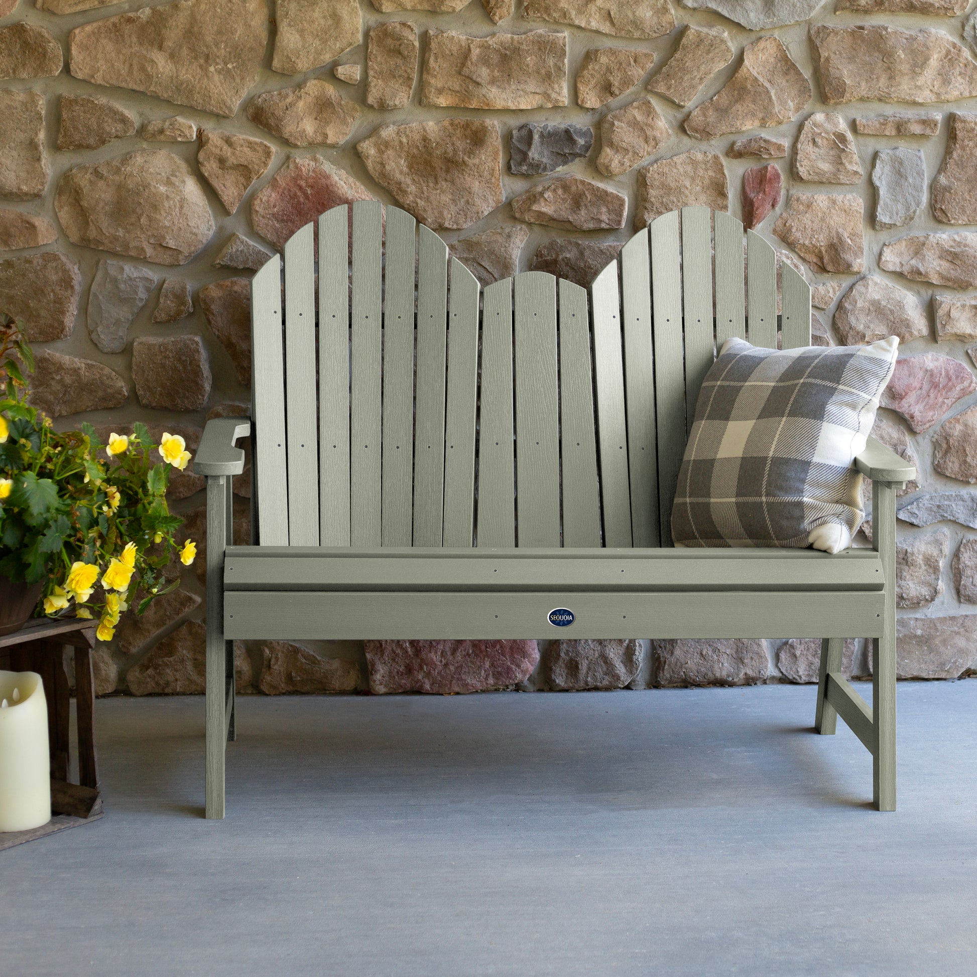 Light green Lighthouse Adirondack bench against stone wall