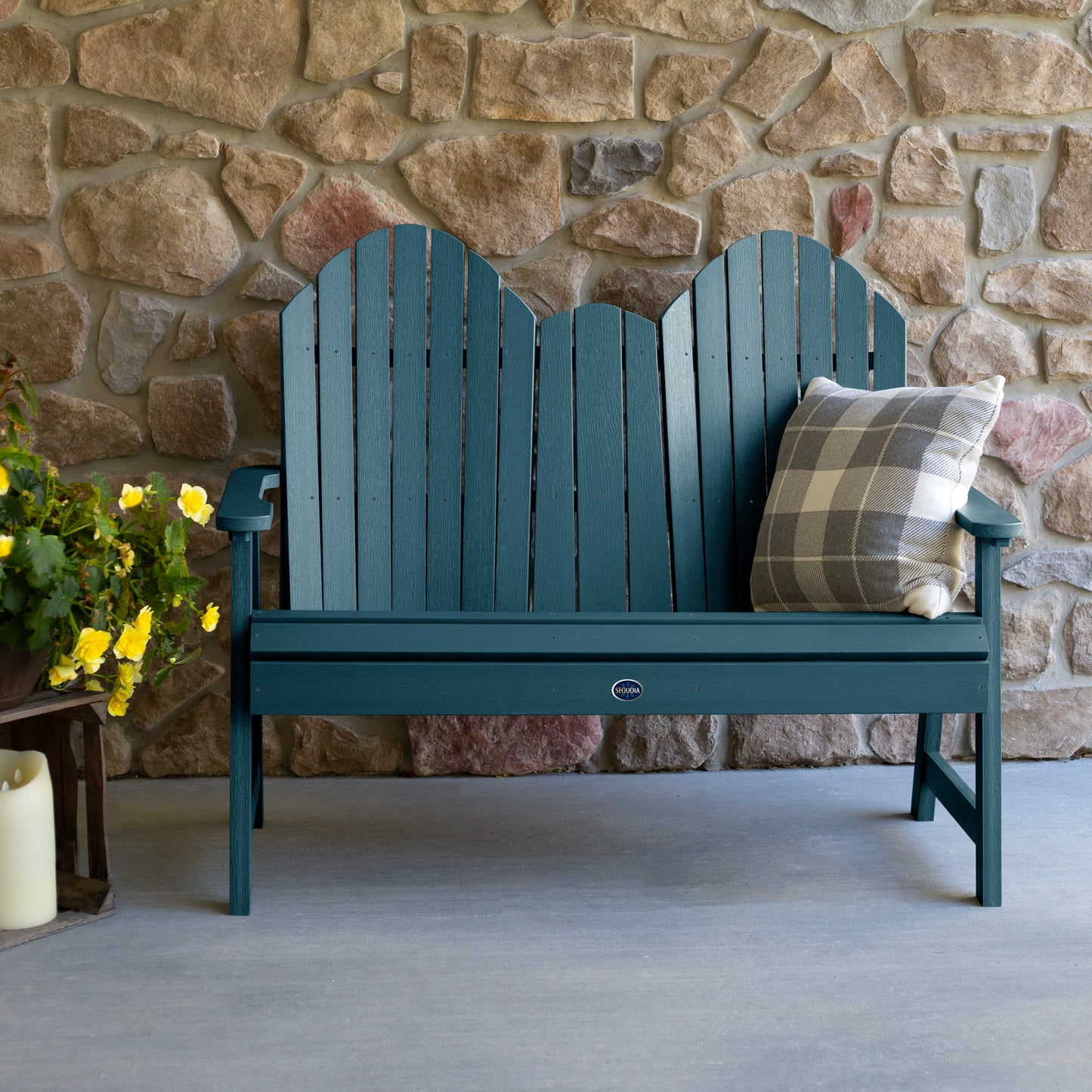 Light blue Lighthouse Adirondack bench against stone wall