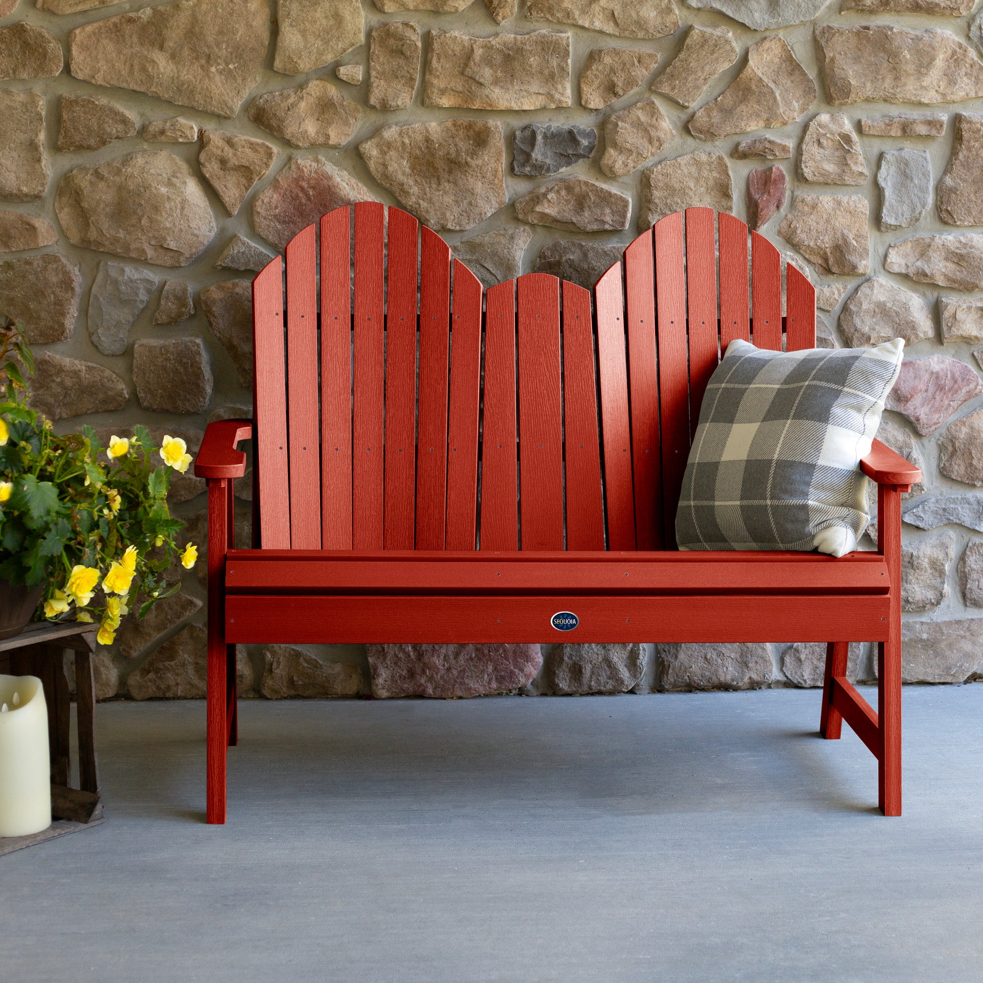 Red Lighthouse Adirondack bench against stone wall