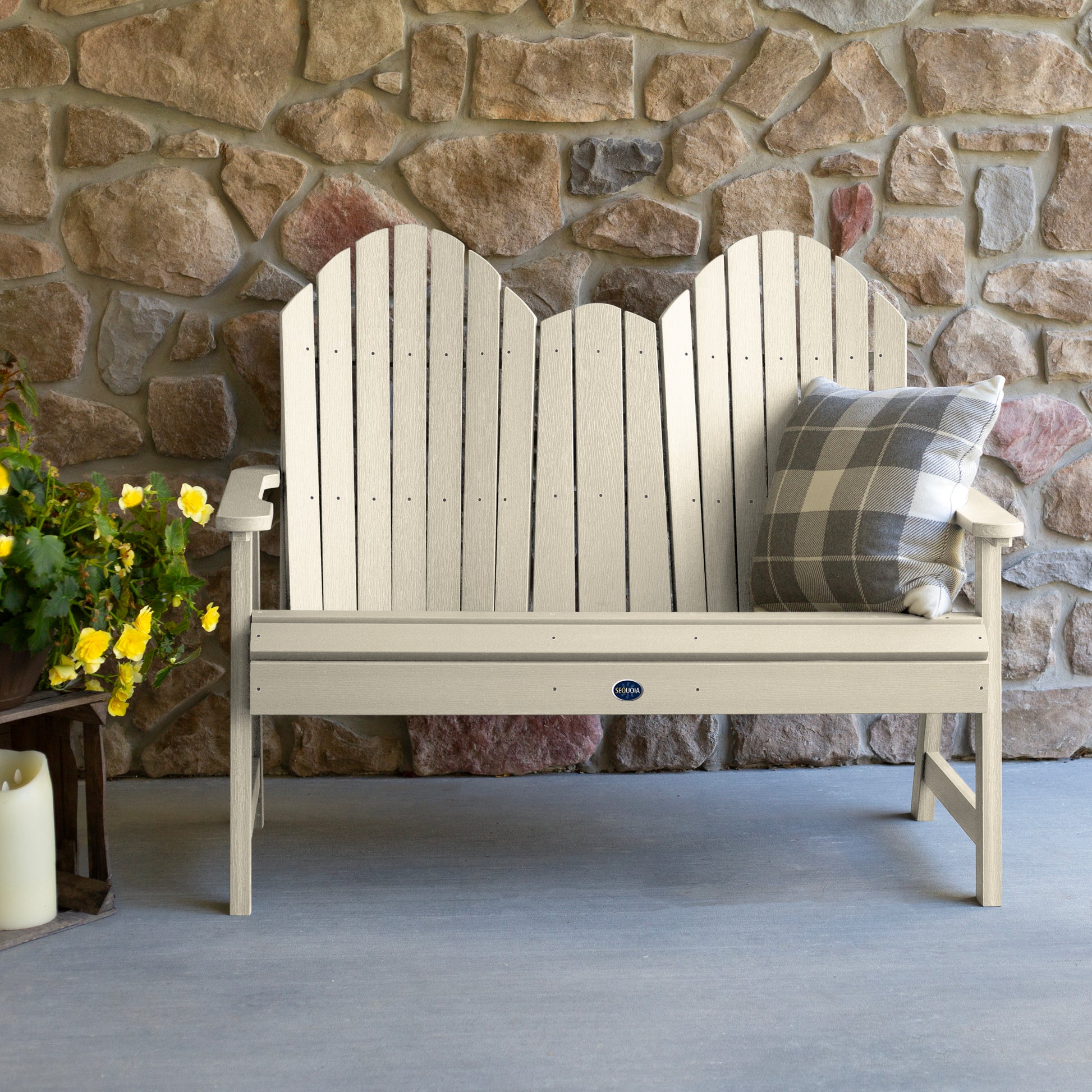 Whitewash Lighthouse Adirondack bench against stone wall