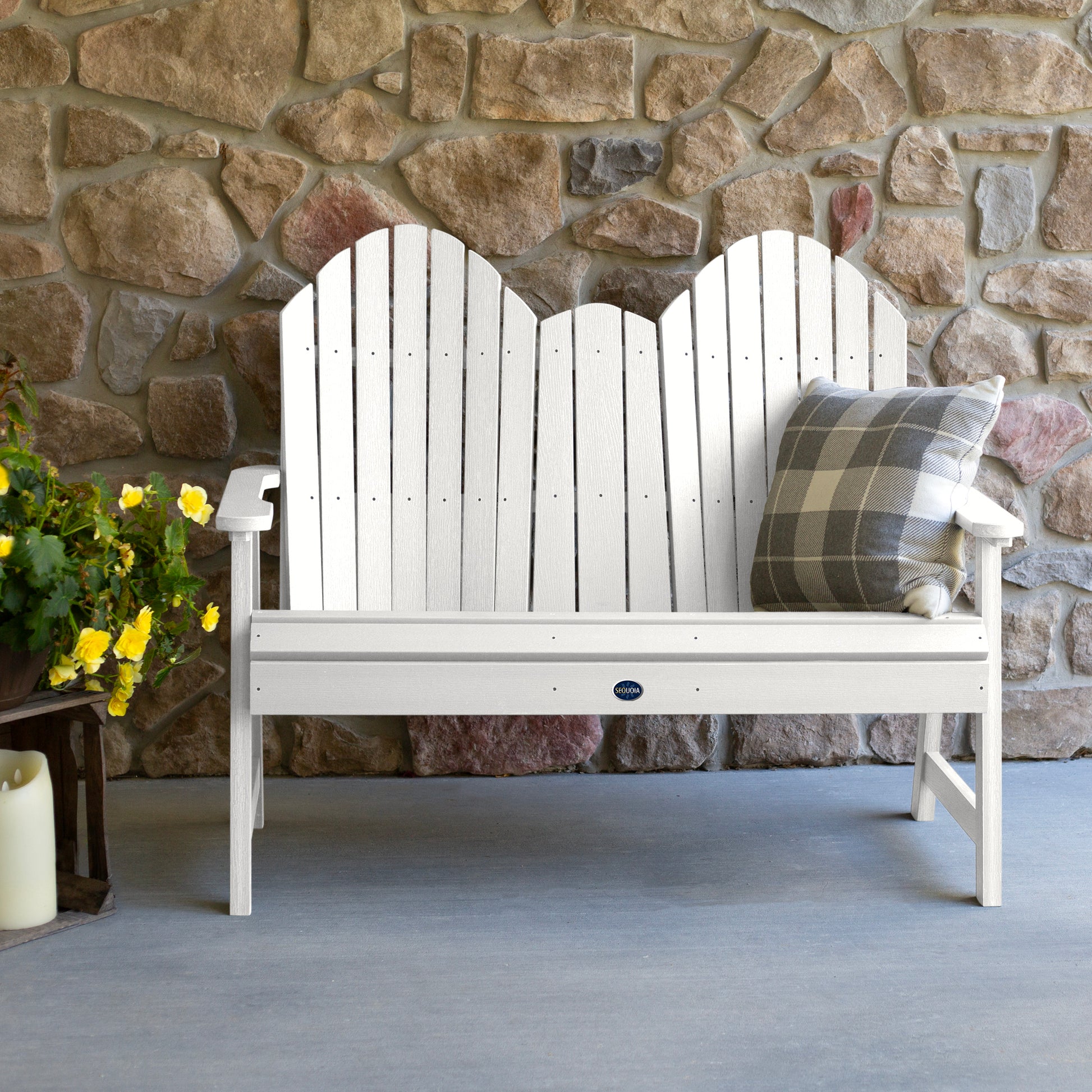 White Lighthouse Adirondack bench against stone wall