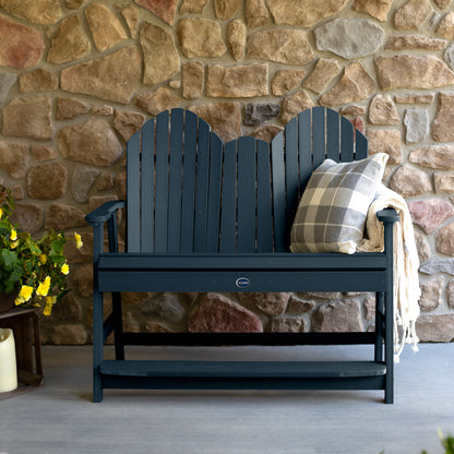 Dark blue Lighthouse counter height Adirondack bench against stone wall
