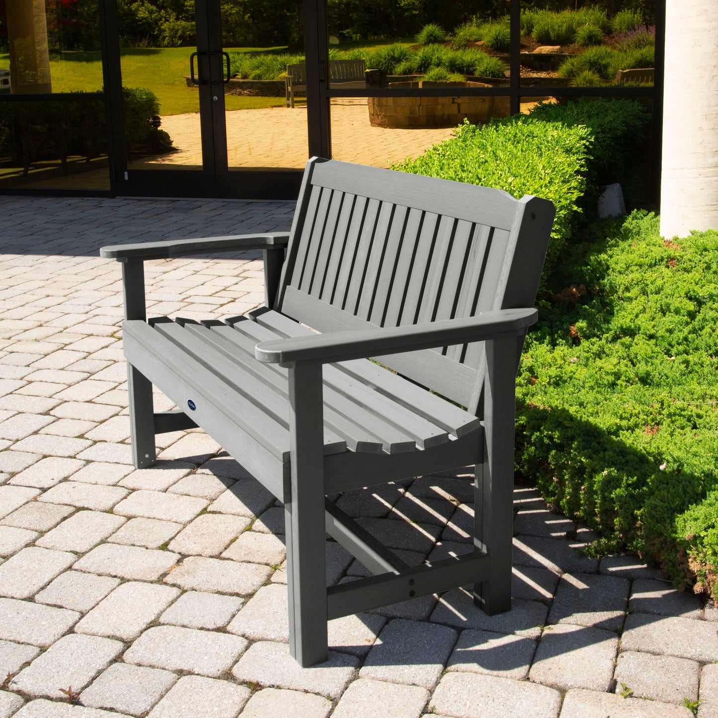 Gray 4ft Blue Ridge Commercial Garden Bench on stone pathway