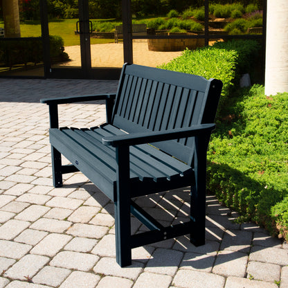 Dark blue 4ft Blue Ridge Commercial Garden Bench on stone pathway