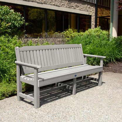 Light gray 6ft Blue Ridge Garden Bench with bushes in background
