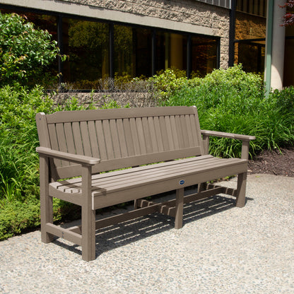 Light brown 6ft Blue Ridge Garden Bench with bushes in background
