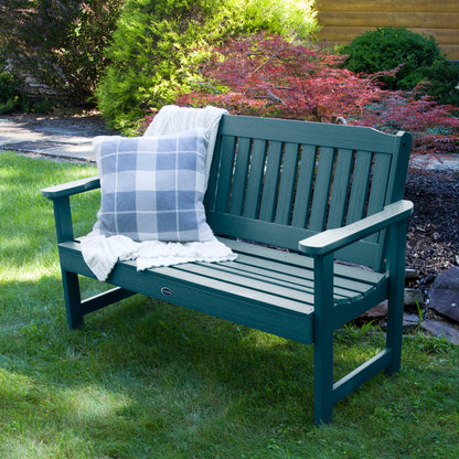 4ft light blue Blue Ridge garden bench on grass with blanket and pillow