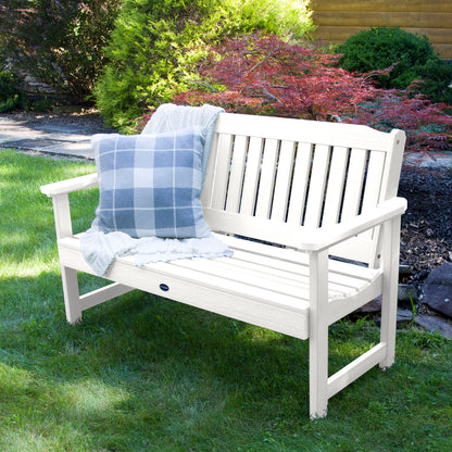 4ft White Blue Ridge garden bench on grass with blanket  and pillow