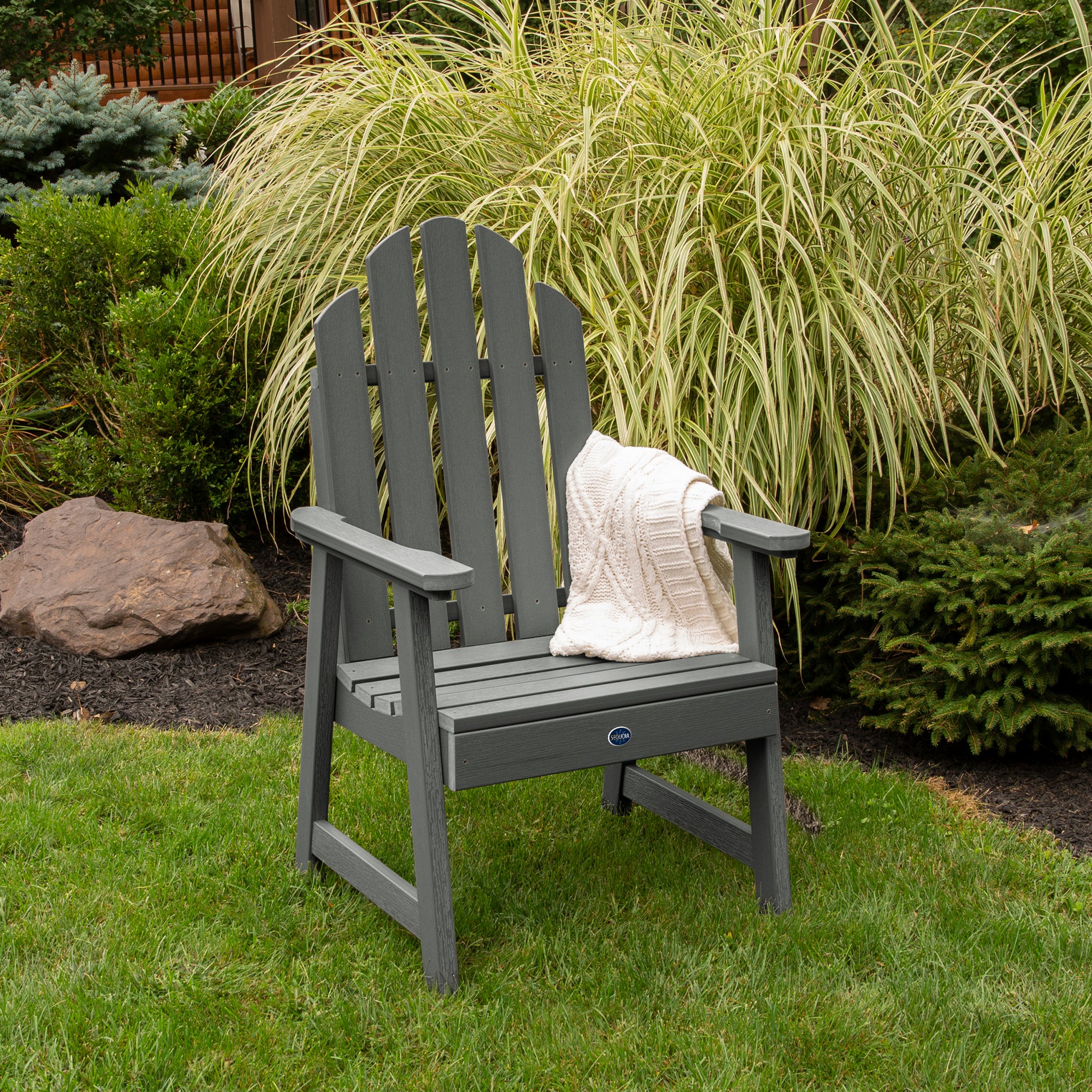 Gray Lighthouse Garden Chair on grass in front of bushes