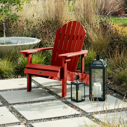 Red Horizon Adirondack chair on stone next to lanterns
