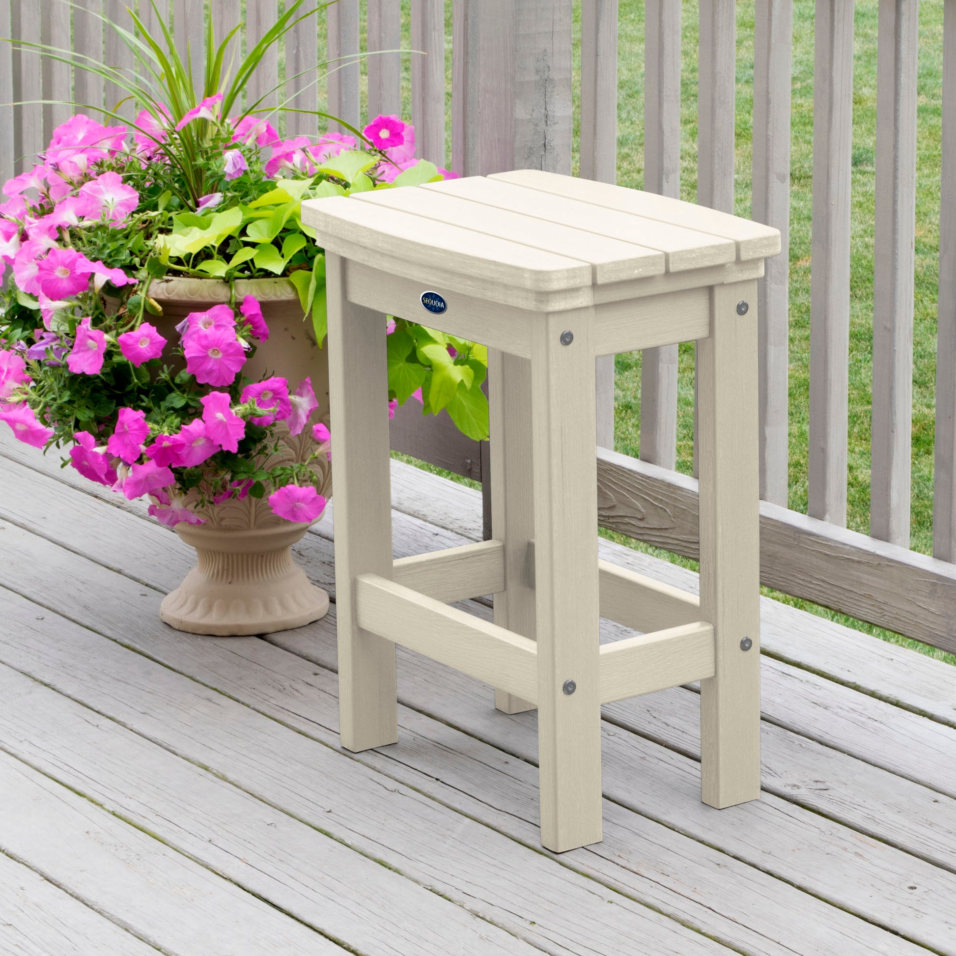 Whitewash Blue Ridge counter height stool on tan wooden deck next to flowers