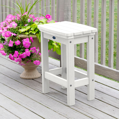 White Ridge counter height stool on tan wooden deck next to flowers