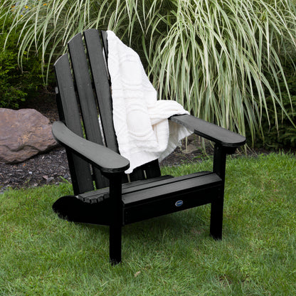 Black Lighthouse Classic Adirondack Chair with blanket on grass