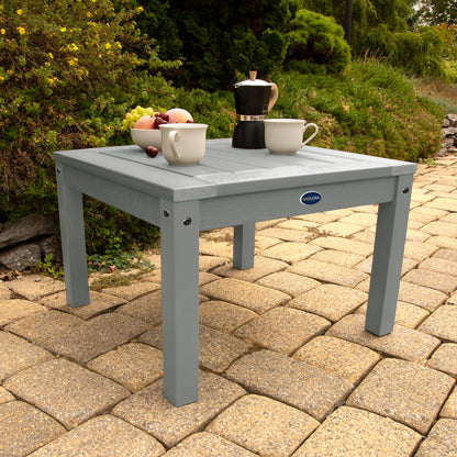 Gray Adirondack side table with coffee and fruit bowl