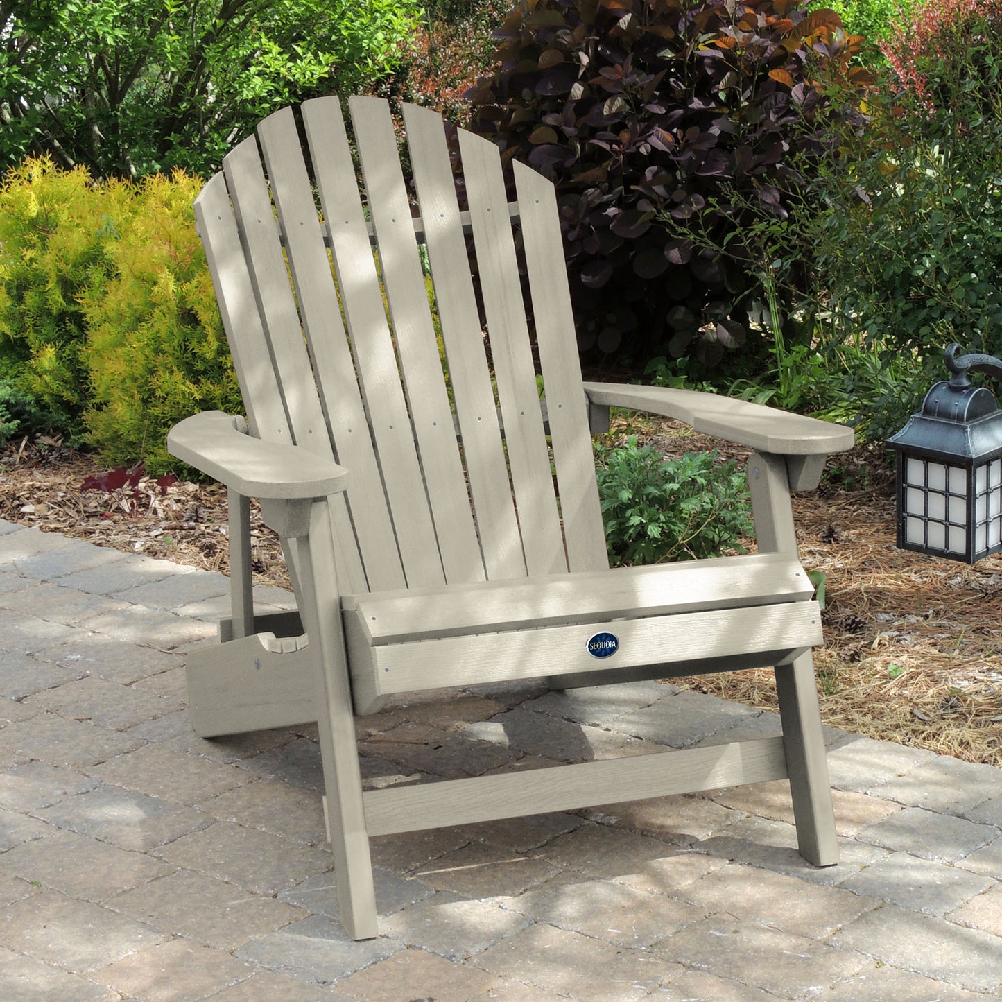 Whitewash Horizon Adirondack chair on stone with trees in background