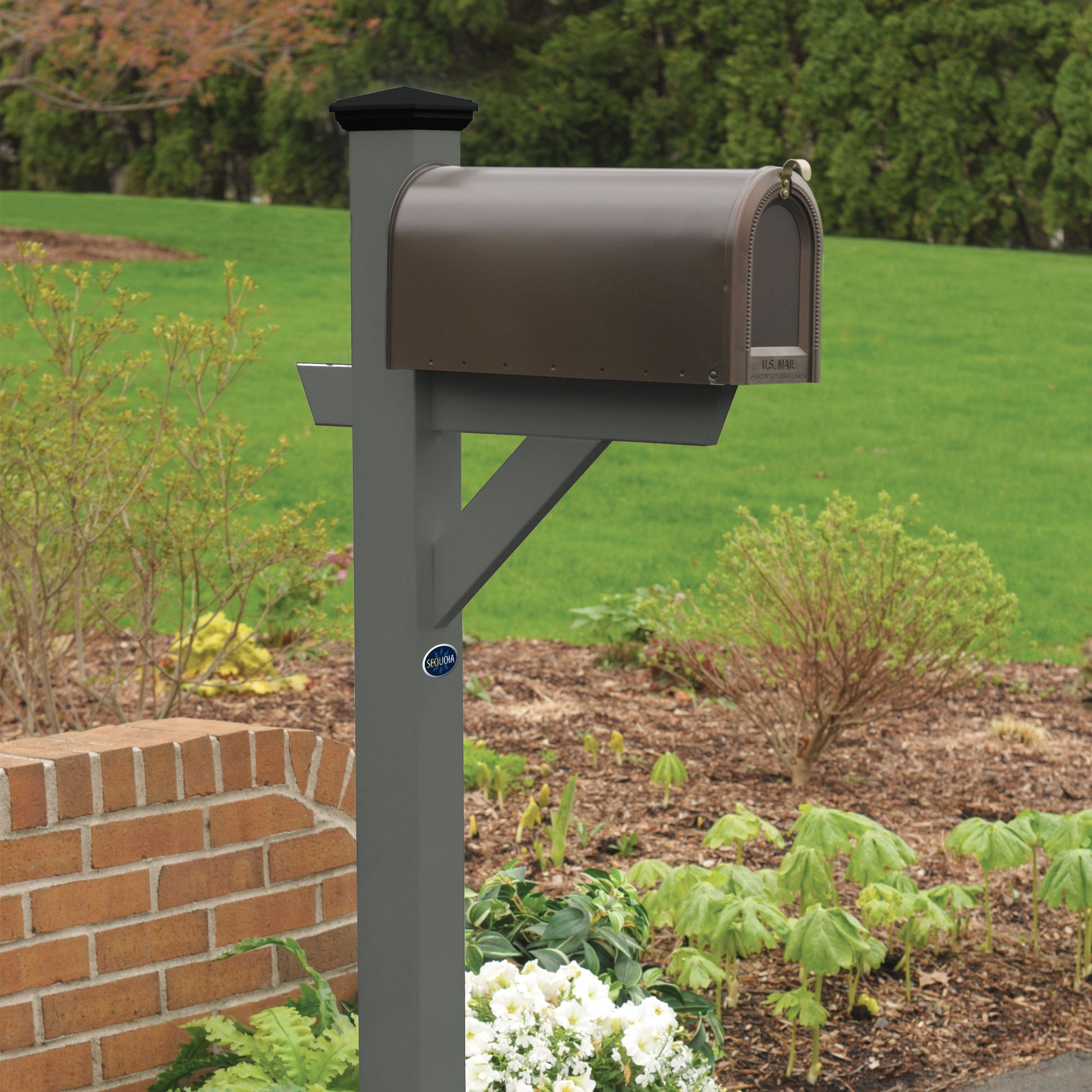 Gray St. Clair Mailbox post standing in flower bed