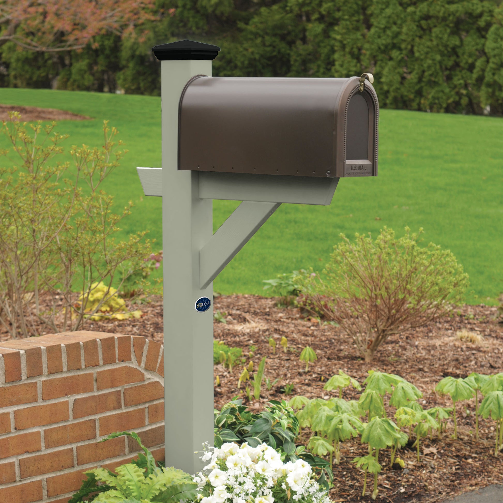 Light green St. Clair Mailbox post standing in flower bed