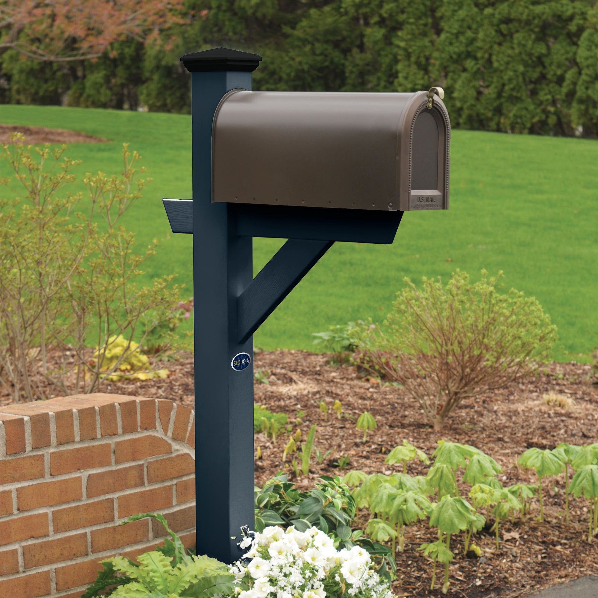 Dark Blue St. Clair Mailbox post standing in flower bed