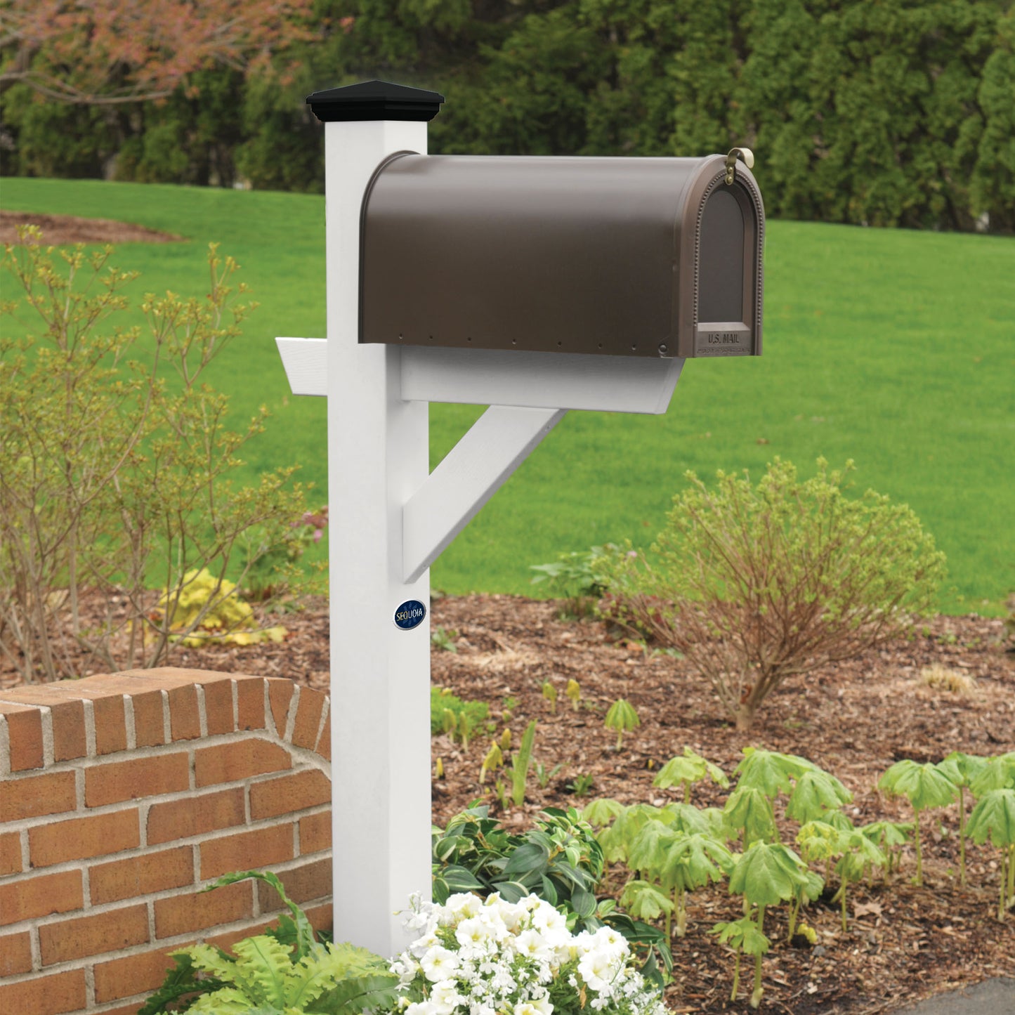 White St. Clair Mailbox post standing in flower bed