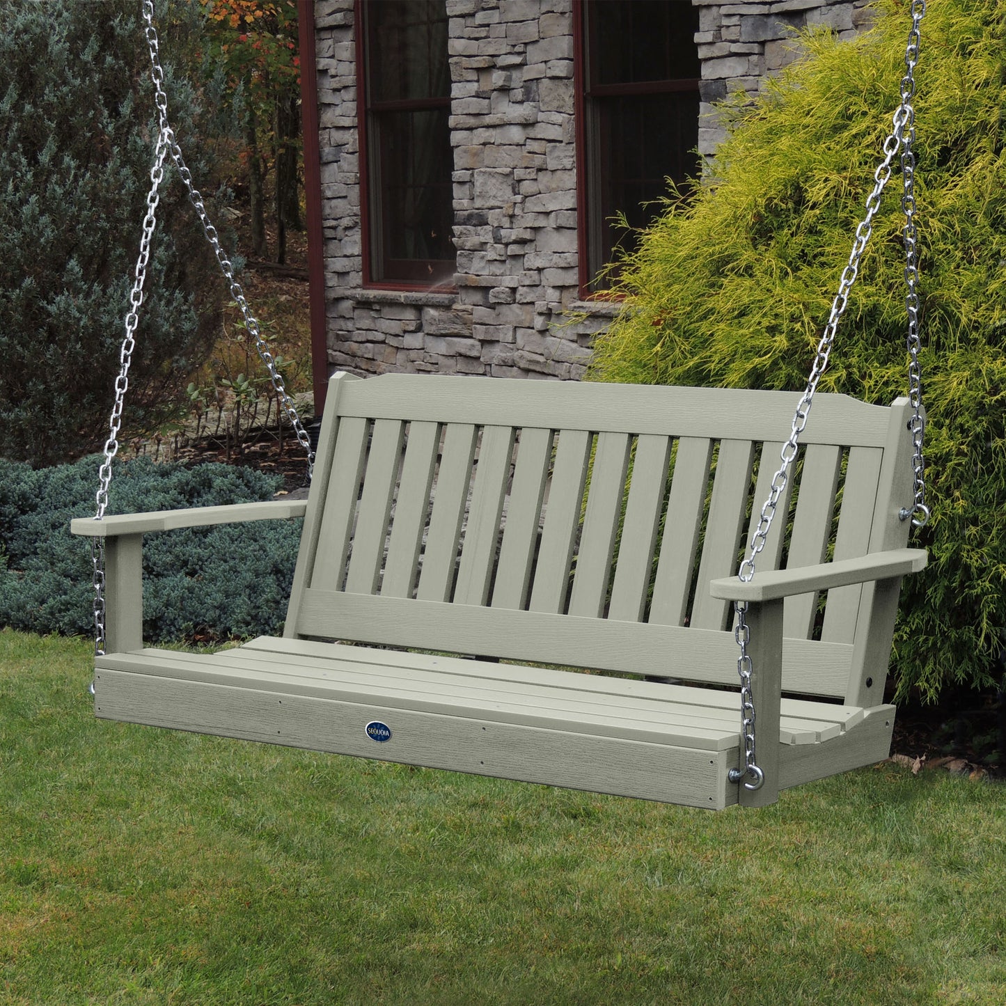 Light green 5ft Blue Ridge porch swing with stone house in background