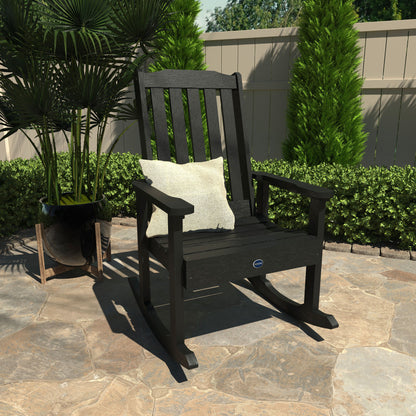 Black Blue Ridge rocking chair on stone patio with pillow