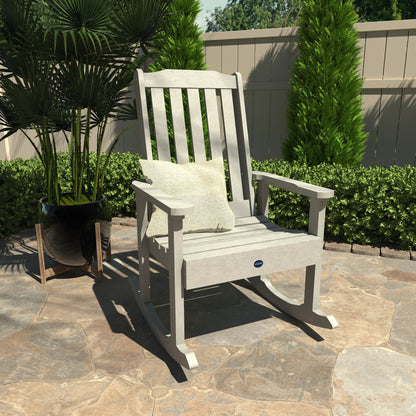 Light gray Blue Ridge rocking chair on stone patio with pillow