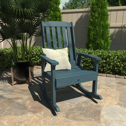 Light blue Blue Ridge rocking chair on stone patio with pillow