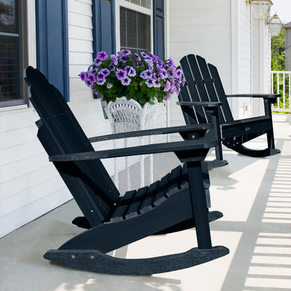 Two dark blue Lighthouse Adirondack rocking chairs on front porch with flowers