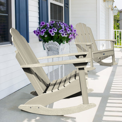 Two whitewash Lighthouse Adirondack rocking chairs on front porch with flowers