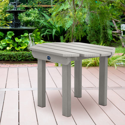 Light gray Lighthouse side table on wooden patio