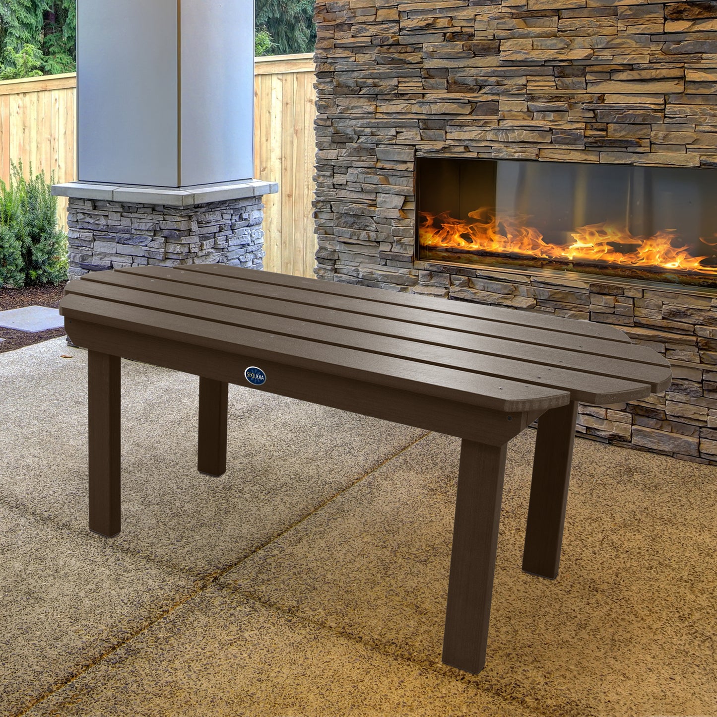 Brown Lighthouse conversation table in front of outdoor fireplace 