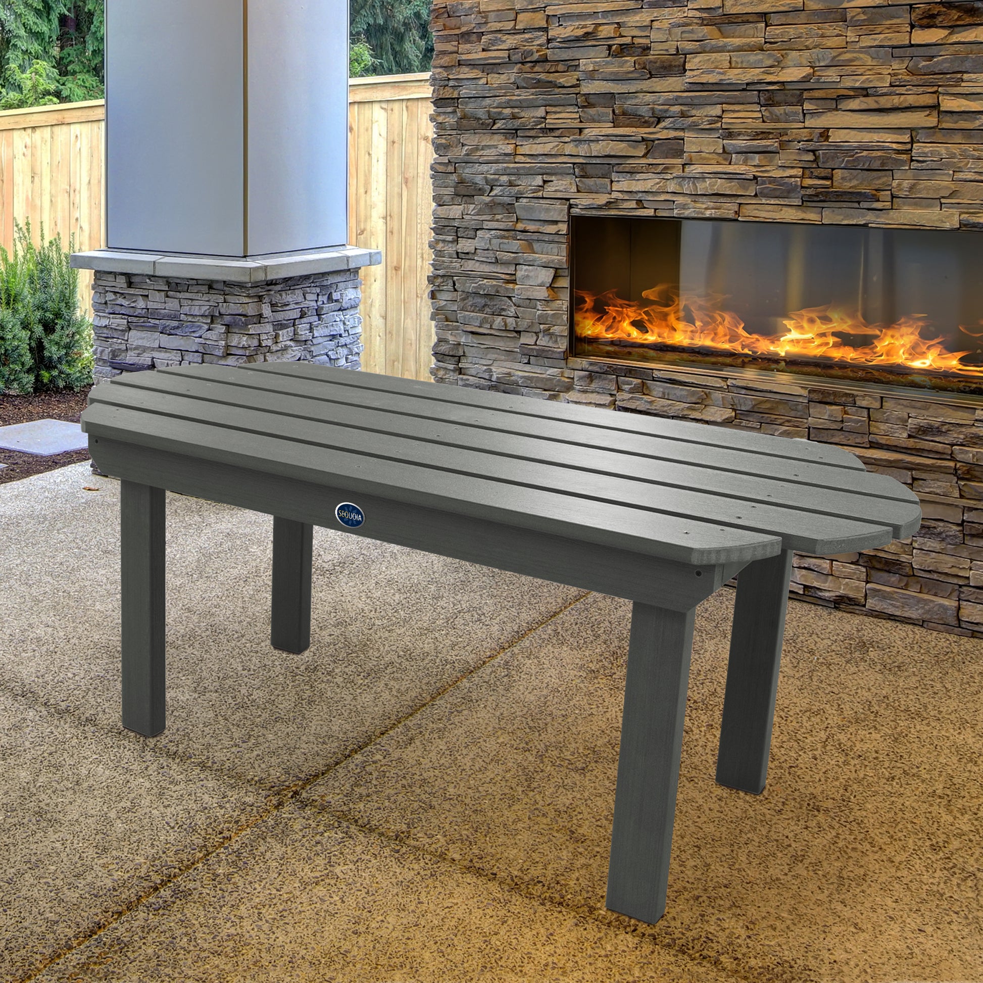 Gray Lighthouse conversation table in front of outdoor fireplace 