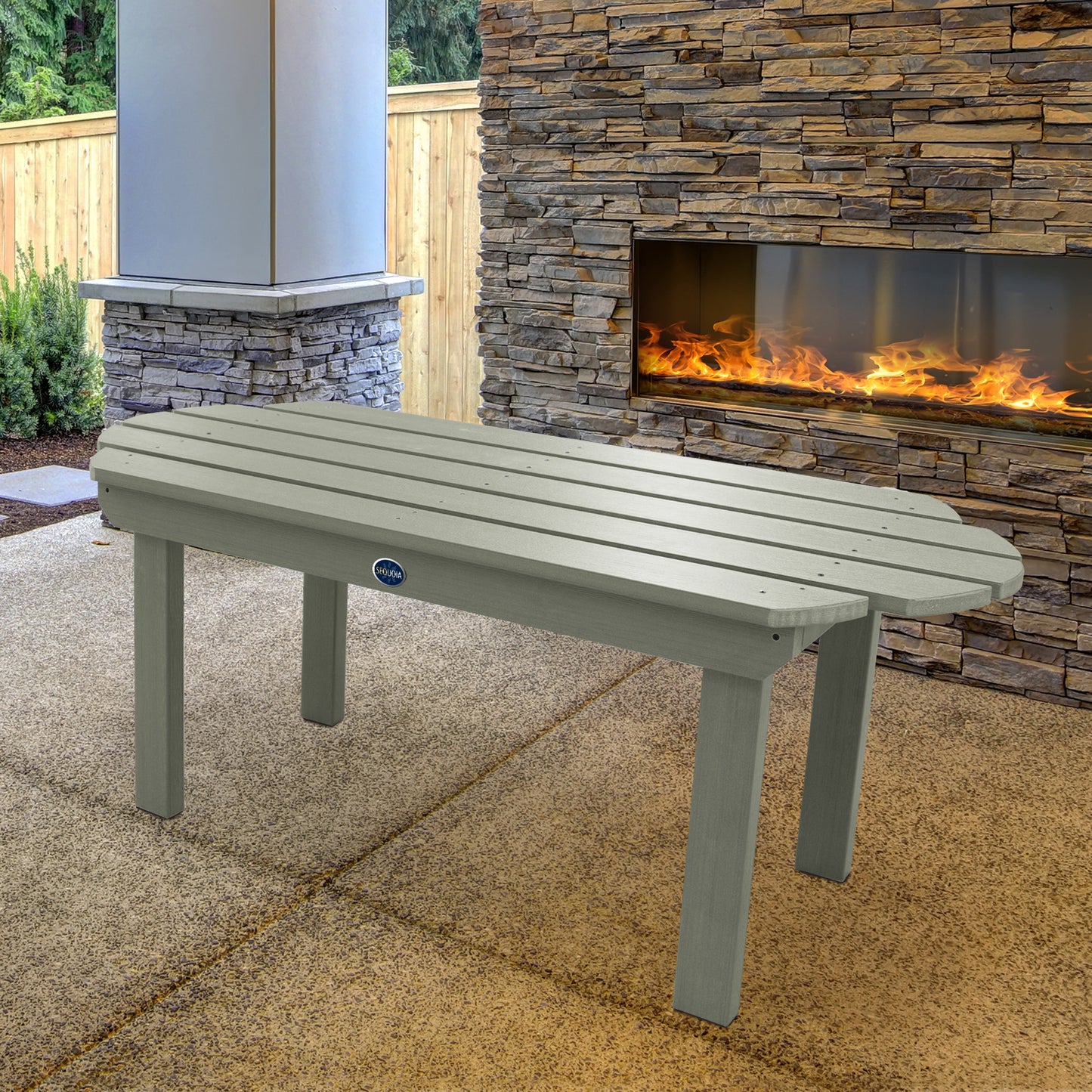 Light green Lighthouse conversation table in front of outdoor fireplace 