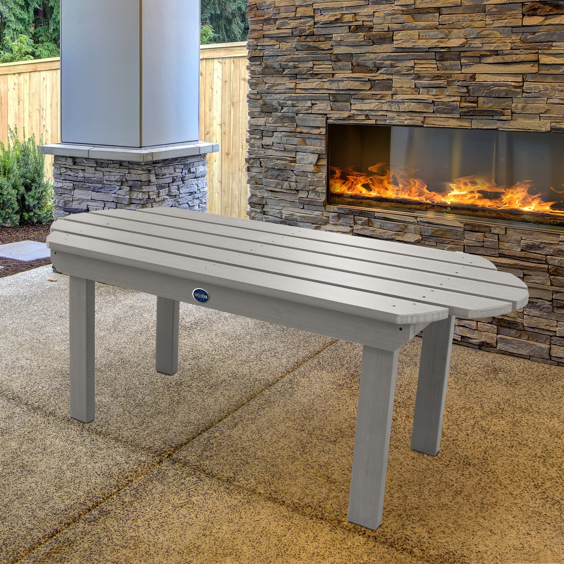 Light gray Lighthouse conversation table in front of outdoor fireplace 